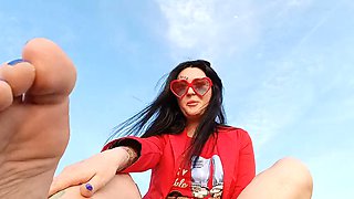 Foot fetish on the beach by the sea. Mistress Nika smokes and seduces you with her feet and toes