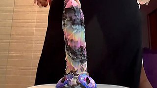 Busty ebony slut stains the camera squirting as she rides a dildo