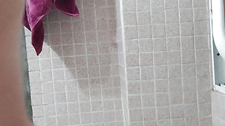 Busty wife fingers in pussy and ass in the bathroom