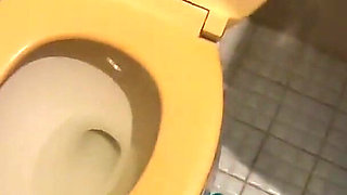 She is pissing standing to the toilet