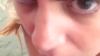 My wife participates in an orgy on the beach. She sucks cock several men