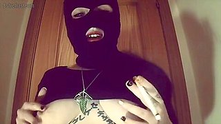 Girl With A Mask Plays With Her Tits And Smokes A Cigarette