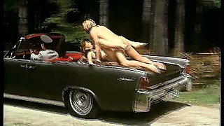 Retro girl gets fucked on top of a driving car
