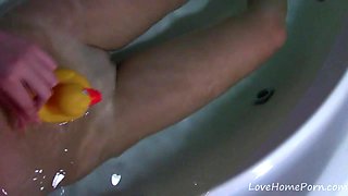 Busty teen in a bath shows her boobs