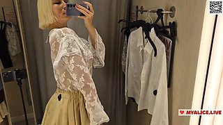 Trying on transparent clothes in the fitting room. Naked blonde flashed her boobs in a public place