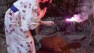 In the open-air bath, she spreads her legs and has a vibrator inserted and removed.