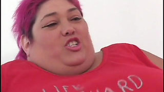 Fat bellied chick in red uniform rides one long stick