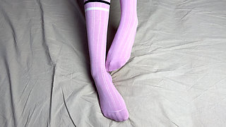 Pink socks in hands of mistress with blue nails in solo video
