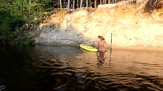 Tattooed Babe Strips and Swims on a SUP Board in the Forest