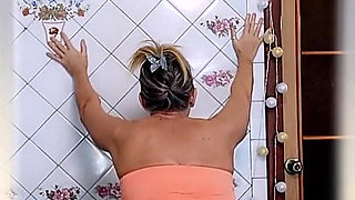 Elderly Housewife Lukerya in the Kitchen. Cheerful Flirtation