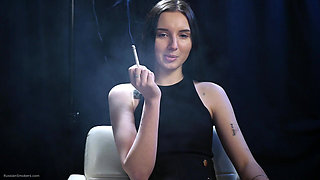 Elegant Brunette Smoking in Black Outfit